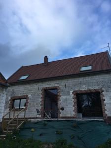 a brick house with a staircase and a roof at Gite de sejour la grange de Théophile in Anzin-Saint-Aubin