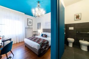 a hotel room with a bed and a toilet at Bibliò Rooms Guesthouse in Bologna