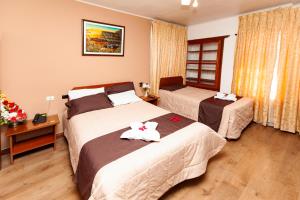Säng eller sängar i ett rum på Hotel Sol del Oriente Cusco