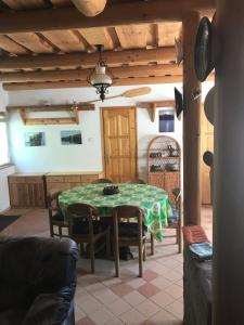 a kitchen with a table and chairs in a room at Van egy ház a Tisza parton in Tiszaderzs