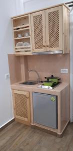 a small kitchen with a sink and a stove at Villa Koronios in Fira