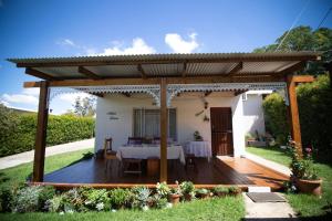a pergola with a table on a wooden deck at Aalkie's Dream in Swellendam