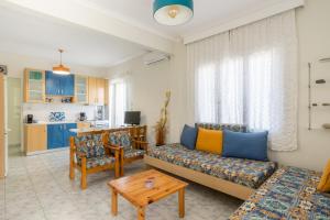 a living room with a couch and a table at Chalkidiki Beachfront Apartment in Nea Irakleia