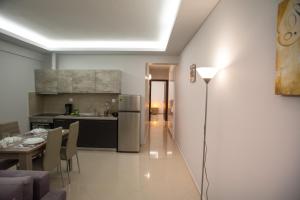 a kitchen and dining room with a table and a refrigerator at DREAM APPARTMENT 3 PEREA in Perea
