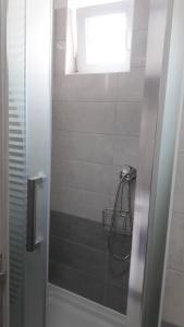 a bathroom with a shower with a window at APARTMANI EMA in Zadar