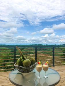 a table with two drinks and a basket of fruit at La Manola Finca Hotel in Doradal