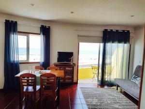 a living room with a table and chairs and a couch at SUNSET house in Moledo