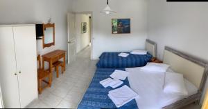 a room with a bed and a couch and a table at Filoxenia Kontogiannis in Lazaráta