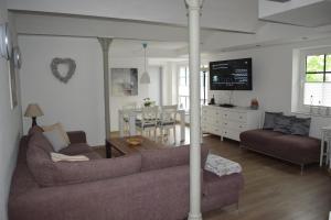 a living room with a couch and a dining room at Gut Kuhfs in Großzössen