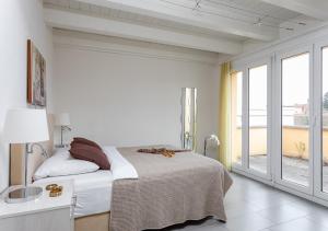 a bedroom with a bed and a large window at Swiss Star District 11 - Self Check-In in Zürich
