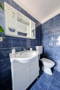 a bathroom with a white sink and a toilet at Apartment Ana & Marko in Zadar