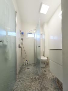 a bathroom with a shower and a toilet at Studio Ariana and patio in Bat Yam