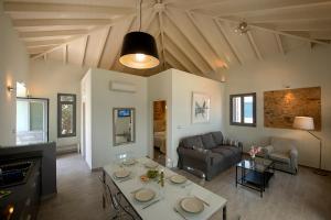 a living room with a table and a couch at Villa Kalypso in Halki