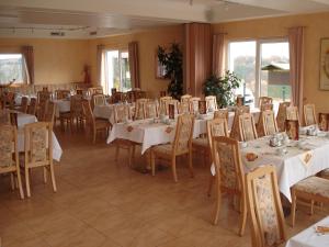 a dining room with white tables and chairs at Panorama Hotel am Frankenstein in Bad Salzungen