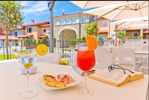 a table with two wine glasses and a plate of food at B&B Le Strade del GAVI in Francavilla Bisio