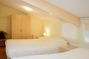 Postel nebo postele na pokoji v ubytování Apartement De Vosseburch