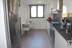 a kitchen with a sink and a counter top at Suite Home Los Alamos sol, playa y golf , parking&Wifi in Torremolinos
