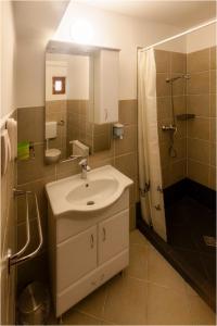 a bathroom with a sink and a shower at Róma Apartmanház in Bogács +54 photos