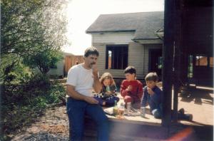 a man and three children sitting around a picnic table at Pescadero Creek Inn in Pescadero
