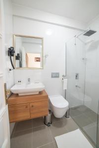 a bathroom with a sink and a toilet and a mirror at 9Bodrum Hotel in Turgutreis