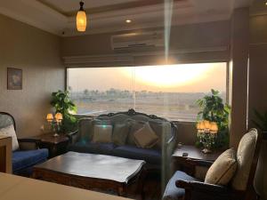 a living room with a couch and a large window at Dorar Rabigh Complex Residential Units in Rabigh