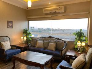 a living room with a couch and a table and a window at Dorar Rabigh Complex Residential Units in Rabigh