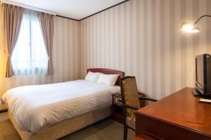 Postel nebo postele na pokoji v ubytování TsukubaNoYu Urban Hotel + 37 fotografií