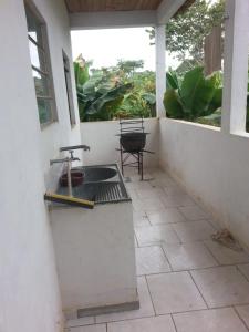 a outdoor kitchen with a sink on a patio at Casa Rustica Milho Verde in Milho Verde