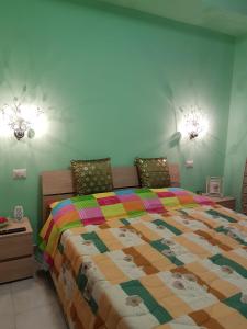 a bedroom with a bed with a colorful quilt at B&B la casetta di Lilly in Amelia