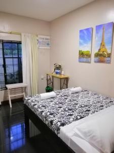 a bedroom with a bed and a view of the eiffel tower at Blue Residence Tagaytay in Tagaytay