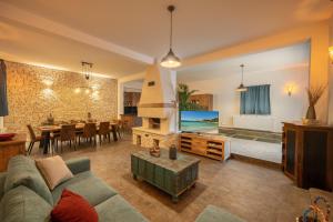 a living room with a couch and a dining room at Nomad Luxury Villa in Vodice