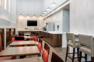 a restaurant with wooden tables and chairs and a tv at Comfort Inn Prospect Park-Brooklyn in Brooklyn