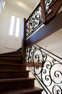 a set of stairs with a wrought iron railing at Studio 5 - Saint George Accommodation in Melbourne