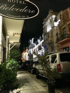 a street with cars parked on a street with buildings at Romantic in Batumi