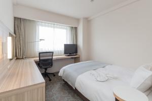 Postel nebo postele na pokoji v ubytování Kusatsu Estopia Hotel + 5 fotografií