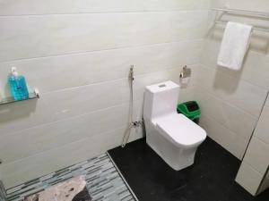 a bathroom with a white toilet in a room at Blue Residence Tagaytay in Tagaytay