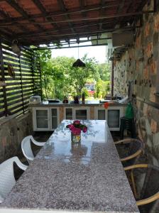 a kitchen with a long table with flowers on it at Zapovedni Rai in Primorsko