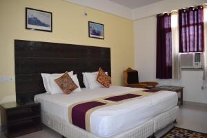 a bedroom with a large bed in a room at Hotel Bodh Vilas in Bodh Gaya