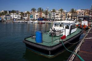 a boat is docked at a dock in the water at Tarragona Ciudad, El Serrallo AP-3 in Tarragona