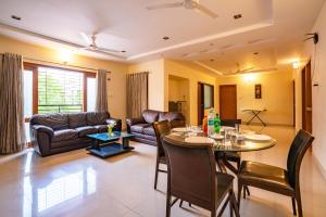 a living room with a table and a couch at Blueberry Service Apartments in Hyderabad