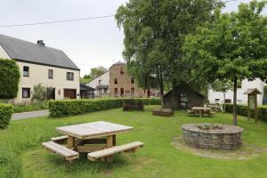 a picnic table and benches in a yard at Gîte de la Lavandière à Ucimont in Ucimont
