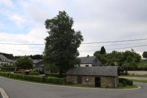 a small stone house on the side of a road at Gîte de la Lavandière à Ucimont in Ucimont