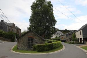 a street in a residential neighborhood with a tree at Gîte de la Lavandière à Ucimont in Ucimont