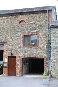 a brick building with a garage with a window at Gîte de la Lavandière à Ucimont in Ucimont +36 photos