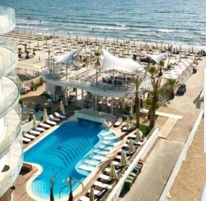a resort with a swimming pool and a beach at White Tower Mamaia Apartament in Mamaia