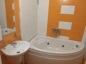 a bathroom with a white tub and a sink at ХОТЕЛ НИК in Asenovgrad +11 photos