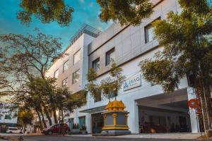 a yellow and yellow fire hydrant in front of a building at Jaag Hotel in Chennai