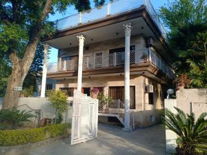 a house with a white gate in front of it at New Islamabad Guest House in Islamabad