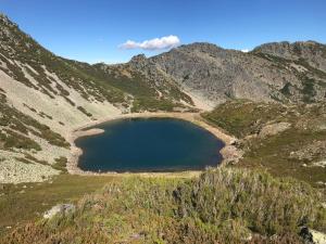 a large blue lake in the middle of a mountain at Tía María in Cerredo