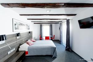a bedroom with a bed and a tv in a room at Willa Oktawia in Niechorze